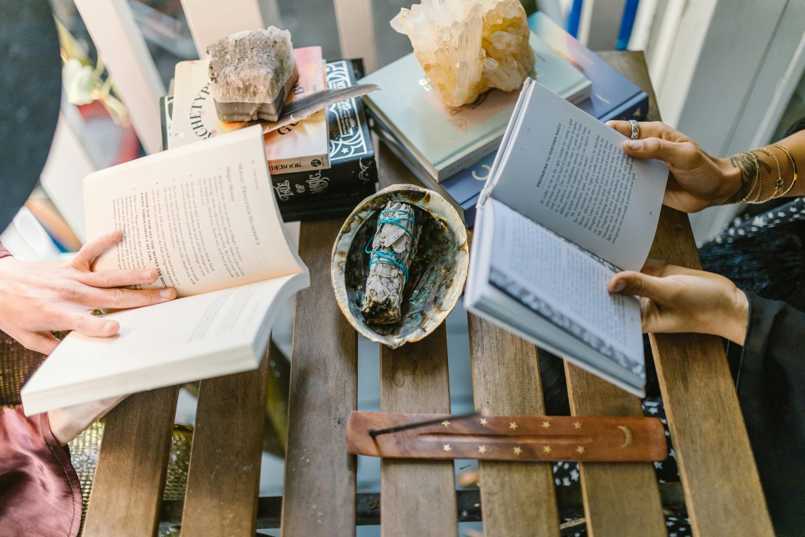 A cozy indoor setup for spiritual reading and crystal healing with books, crystals, and incense.