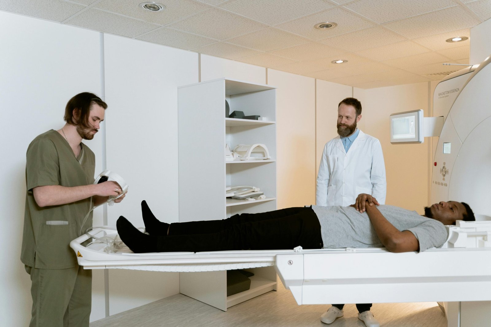 Doctors and patient during MRI scan in medical facility.
