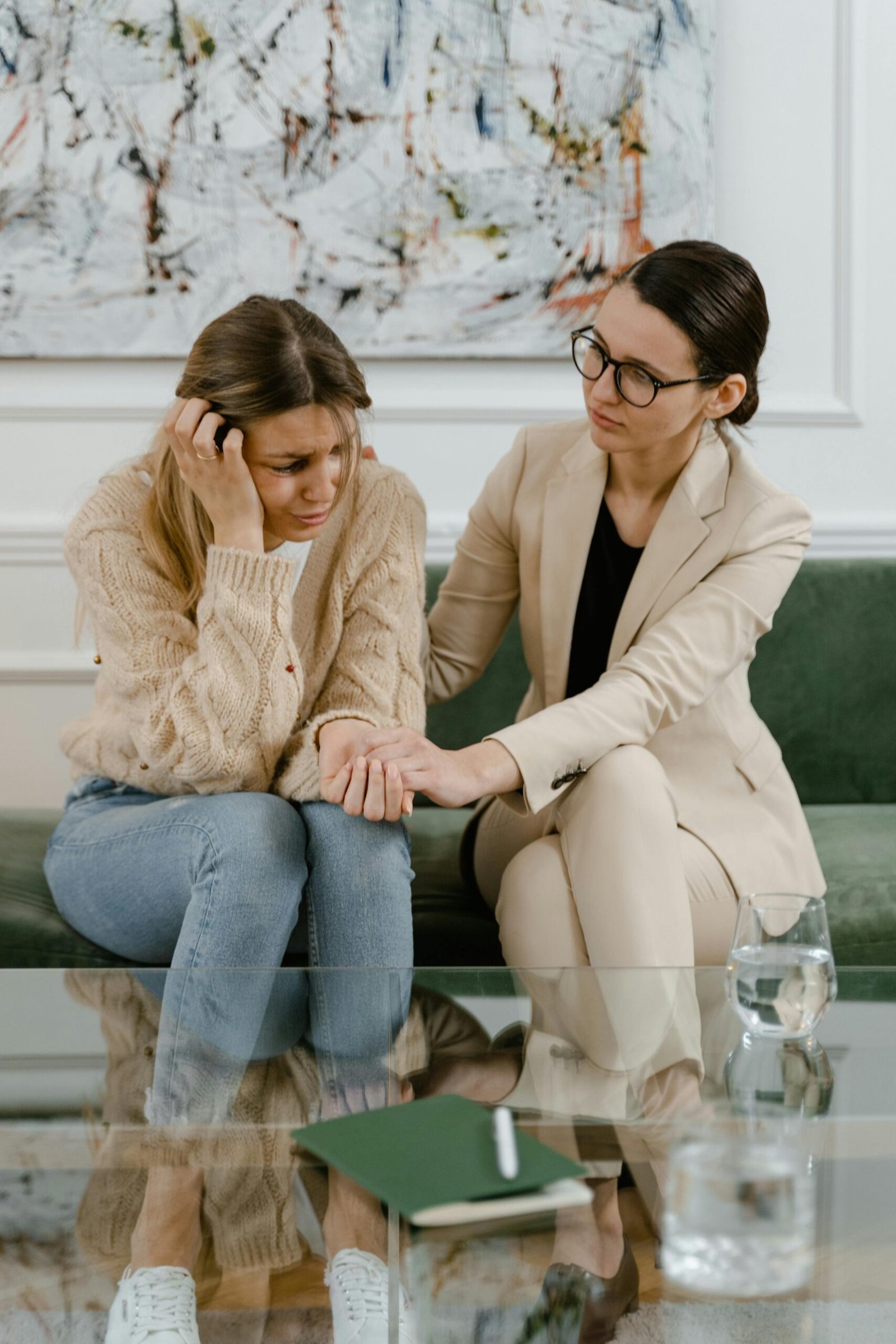 A comforting moment between two women in an indoor setting, showcasing empathy and support.